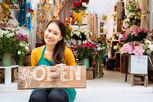 Small business owner in front of shop 