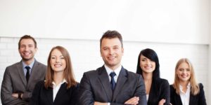 group of certified public accountants that work at a CPA firm smiling
