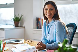 a CPA working at her desk while serving a government contractor