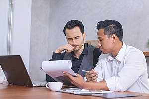 a business owner discussing government contract termination with a consultant