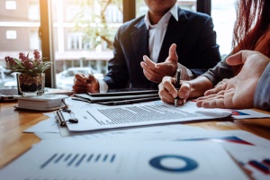 a bookkeeper working with a small business owner to keep track of expenses