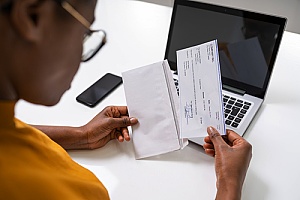 an employee receiving a paycheck due to the help of payroll services