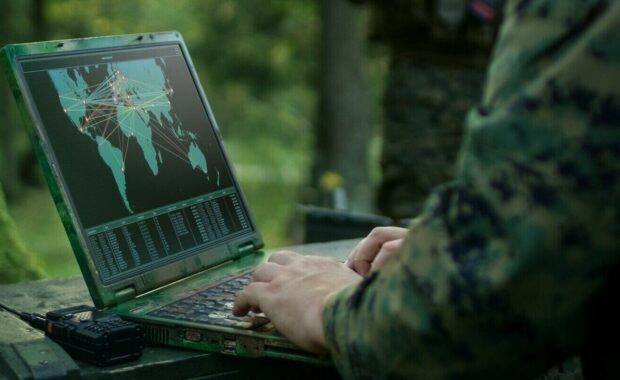 soldiers using military grade laptop targeting enemy with satellite