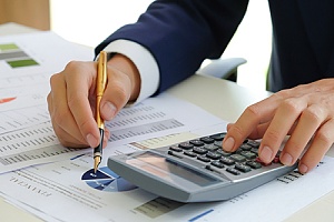 cpa professional working at a desk with calculator