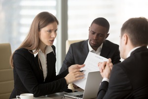 dissatisfied businesswoman holding contract arguing with contractor