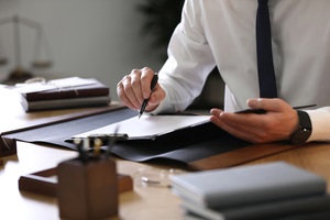 male lawyer working at table in office