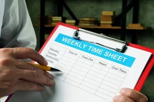 man holding weekly timesheet