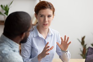 female cpa speaking to an employee about defense contracts