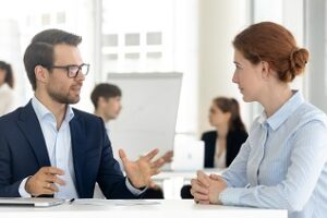 male cpa speaking with a manager during a presentation