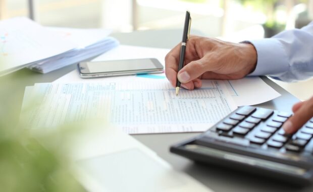 tax accountant working with documents at table