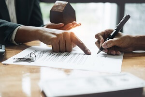 businessman and estate agent signing a document for house deal