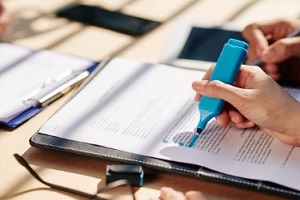 man highlighting lines with blue pen