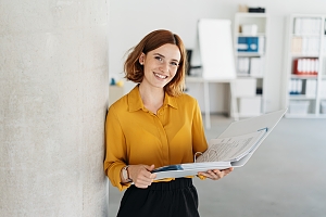 office manager reviewing employee time tracking on a ledger