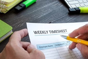 man filling weekly timesheet