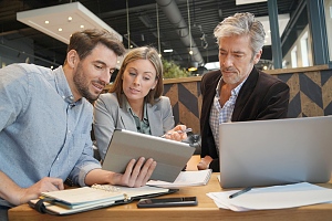 traveling sales reps discussing their plan on a tablet