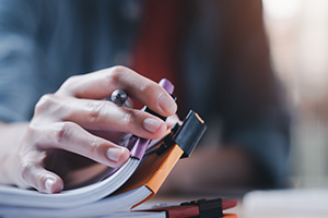 Person at their desk sorting through paper