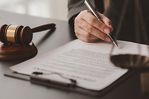 Person writing document at their desk