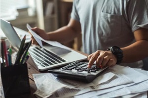 men is calculating the cost of the bill