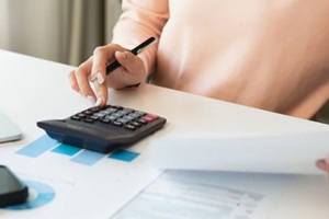 debt asian young woman hand using calculator to calculating money balance from bill and income