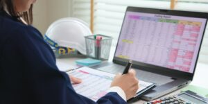 expert woman asian female people review data number costing managerial account prepare monthly actual cost variance report at tax audit office