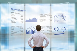 man analyzing financial report on a big screen