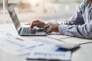 business accountants are using laptops to check financial transactions using laptop software