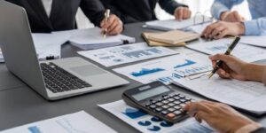 auditor and accountant team working in office, analyze financial data and accounting record with calculator