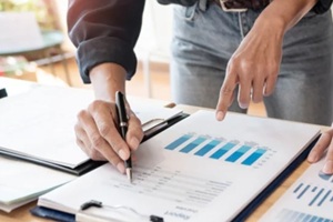 business people meeting to analyse and discuss and brainstorming the financial report chart data in office