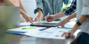 business adviser meeting to analyze and discuss the situation on the financial report workplace office