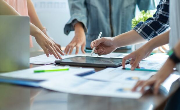 business adviser meeting to analyze and discuss the situation on the financial report workplace office