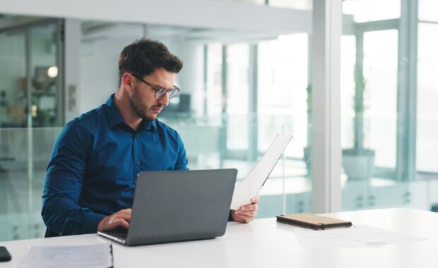 reading and documents with business man in office for research, payroll manager and audit report