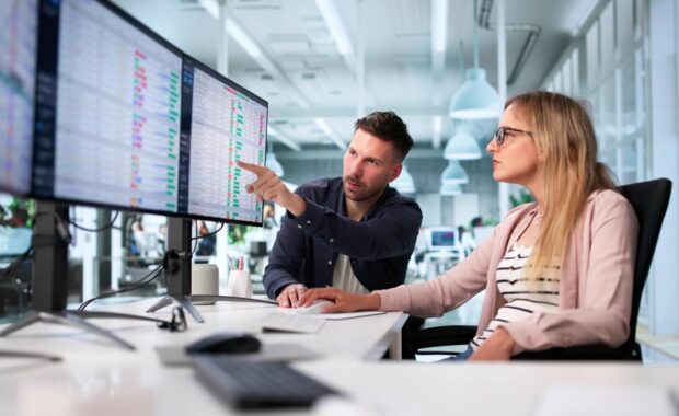 manager reviewing medical billing audit using computer