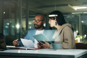 people and meeting with laptop at night for planning, finance report and review budget