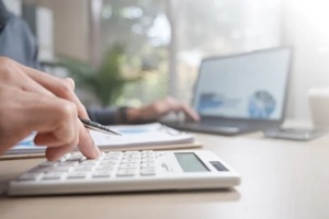 refund, pending, payment, processing, finance, Person reviewing payment transaction and refund status using calculator and laptop