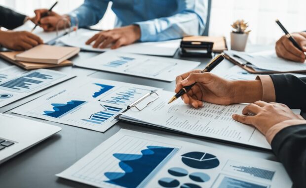 team of analyst working on financial data analysis dashboard on paper as marketing indication for business
