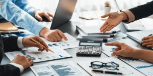 auditor and accountant team working in office, analyze financial data and accounting record with calculator