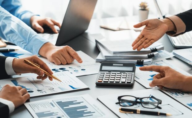 auditor and accountant team working in office, analyze financial data and accounting record with calculator