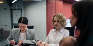 meeting with working mother holding baby in office conference room