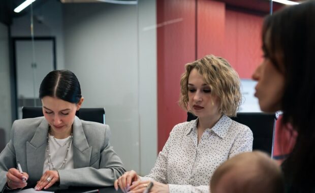 meeting with working mother holding baby in office conference room